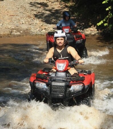 Couple riding ATV together during Manuel Antonio jungle tour